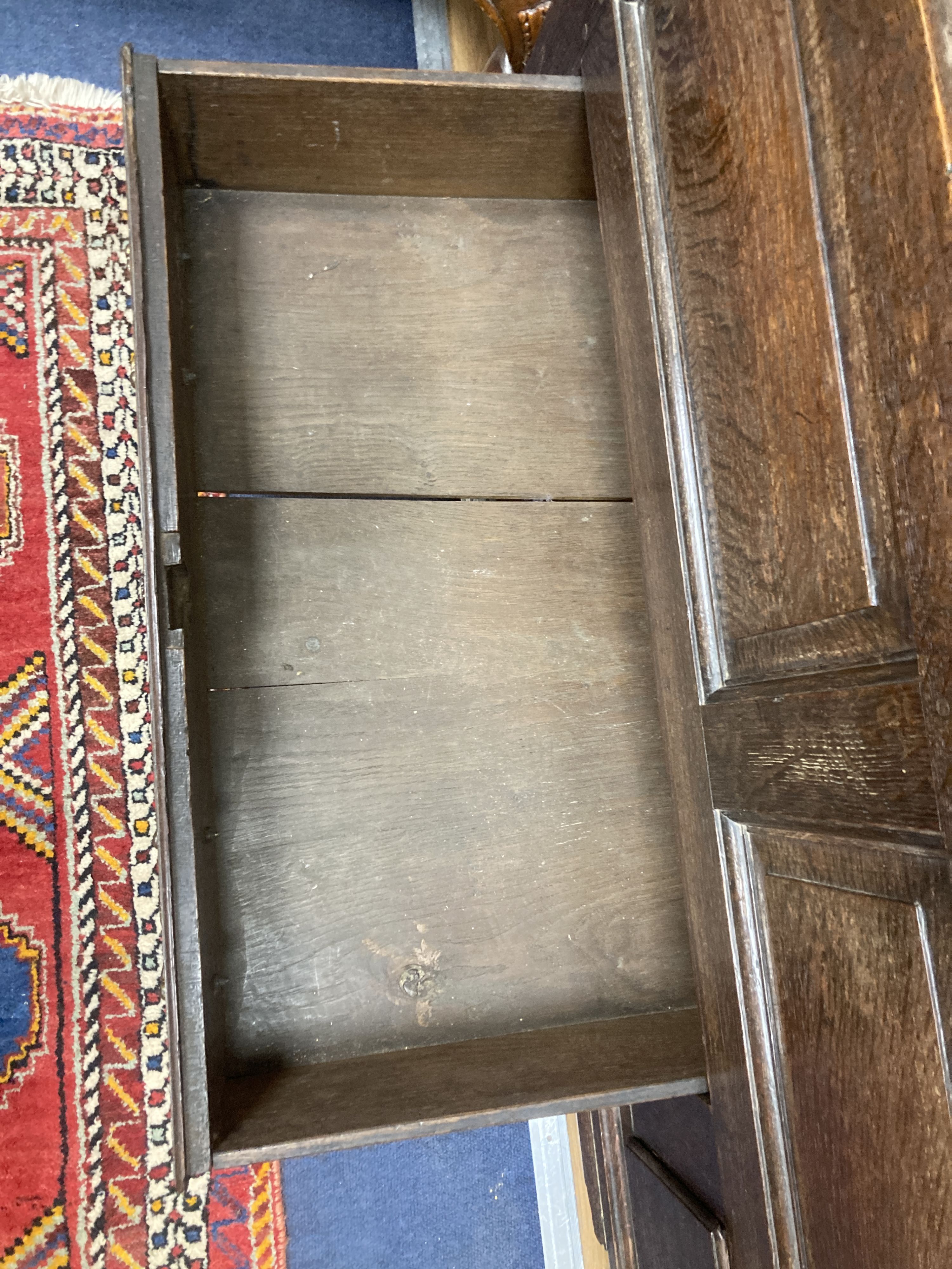 A mid 18th century oak panelled two part hanging cupboard, width 156cm, depth 53cm, height 188cm